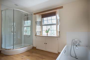 The spacious family bathroom with a large shower cubicle and a good sized bath to relax in after a day out exploring.