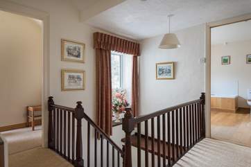 The spacious landing with doors to all bedrooms and the family bathroom.