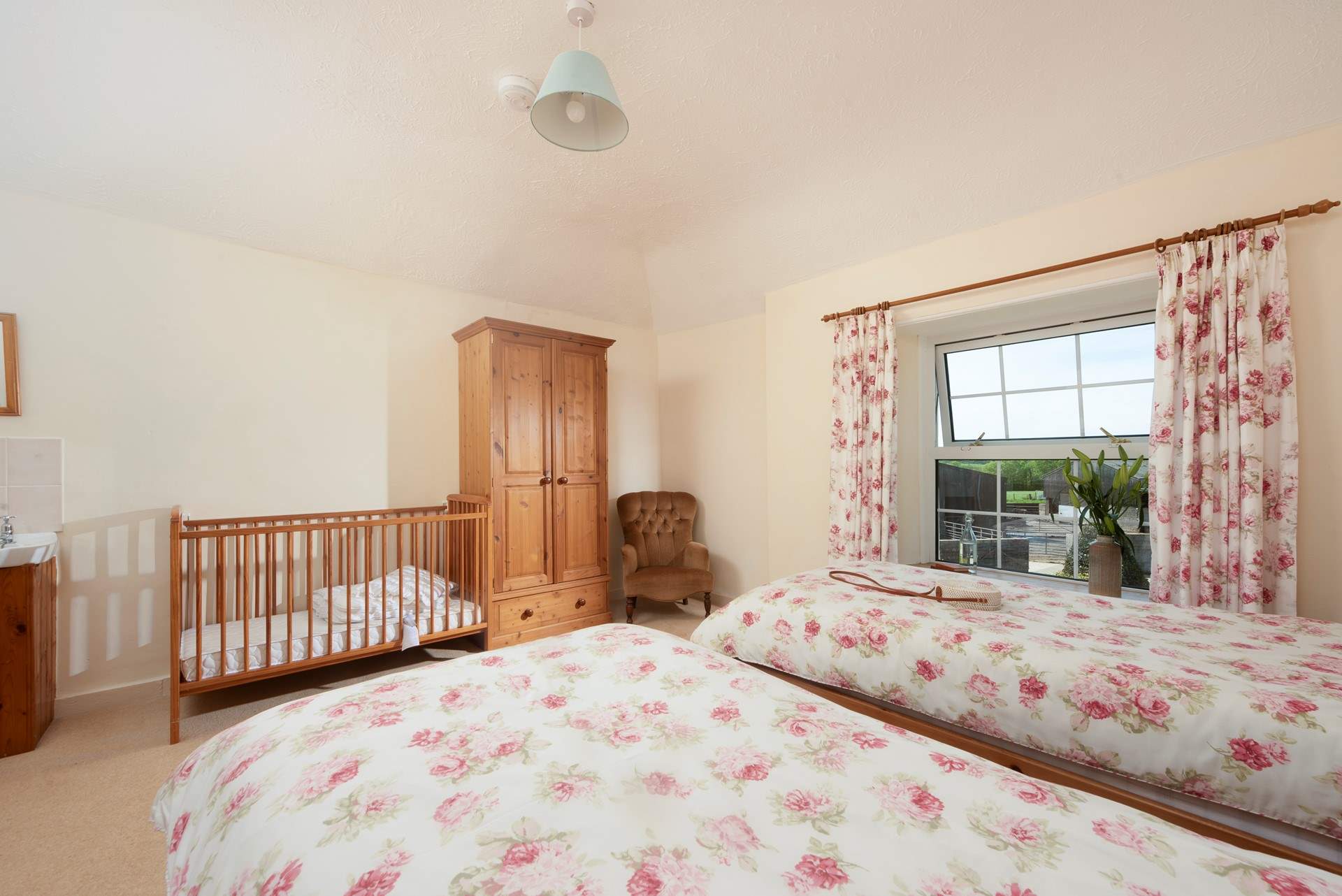 There is a wash basin in this room, plenty of hanging space and a cot is provided for babies on request.