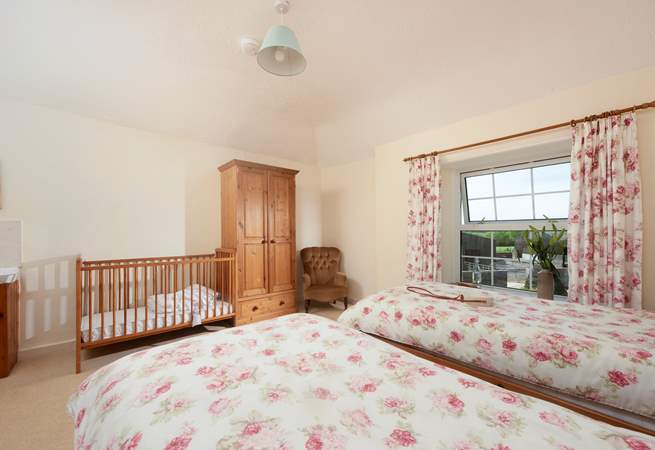 There is a wash basin in this room, plenty of hanging space and a cot is provided for babies on request.