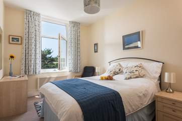 The master bedroom has lovely calming tones.