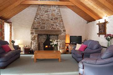 The apex ceiling in the spacious sitting-room enhances the feeling of space and light.