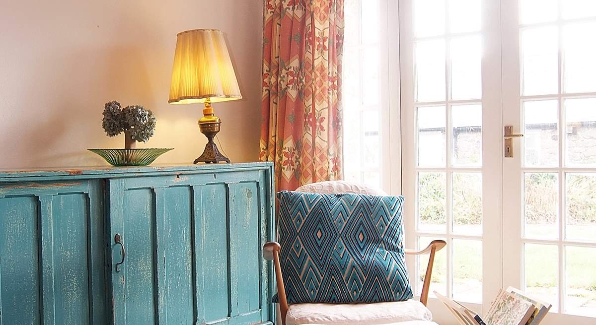 This relaxing chair by the French doors, where the light floods in, provides the perfect place for reading.