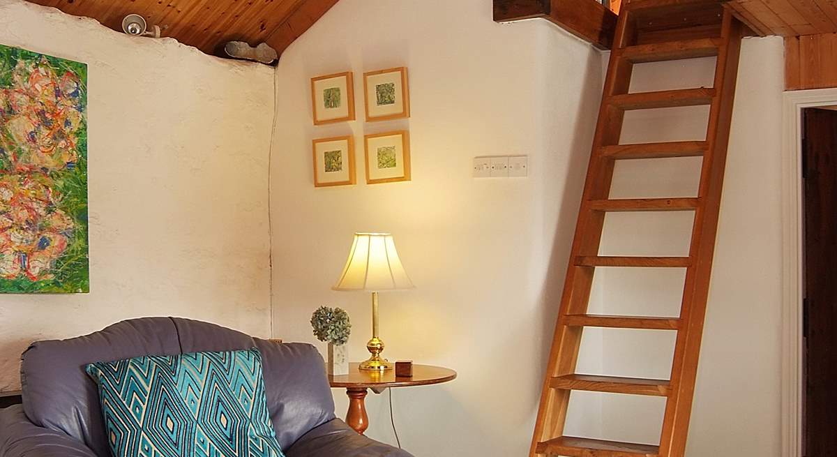 A custom-built ladder leads up to a snug reading-area in the gallery above the sitting-room (please take care with young children).