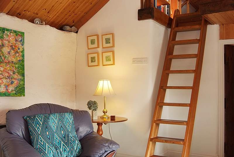 A custom-built ladder leads up to a snug reading-area in the gallery above the sitting-room (please take care with young children).
