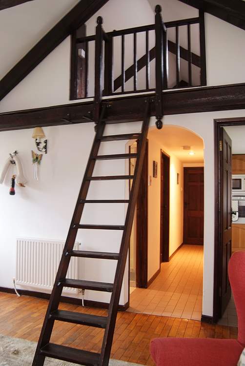 The wall ladder leading up to the mezzanine area, please supervise young children on their way up and down.