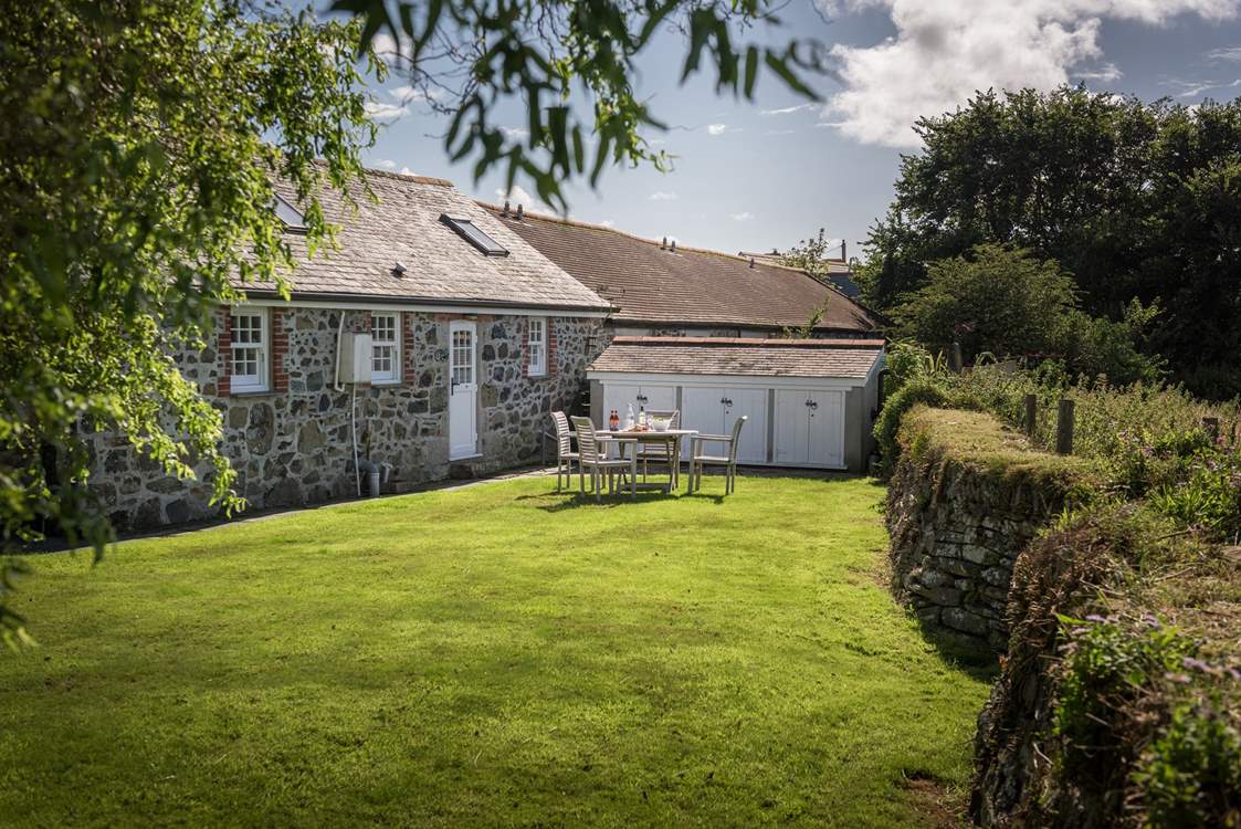 The lovely back garden. The outhouse houses the freezer, washing machine and tumble-drier.
