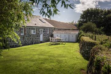 The lovely back garden, the outhouse next to the cottage houses the freezer, washing machine and tumble-drier.