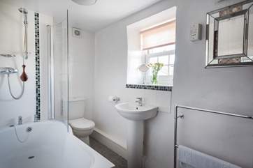 The bathroom is at the end of the hall.