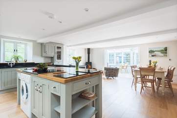 The kitchen/dining-room leads straight through to the conservatory.
