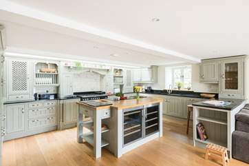The open kitchen/dining-room with bespoke hand-made kitchen is extremely well-equipped.