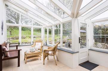 The airy and light filled conservatory, a great spot to relax with family and friends whatever the weather.