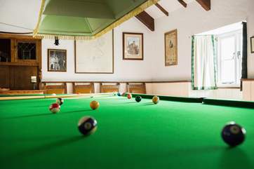 The games-room with full-size snooker table, dart board and a shelf full of games behind the bar!