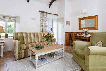 The high ceilings and exposed beams create a lovely light room.