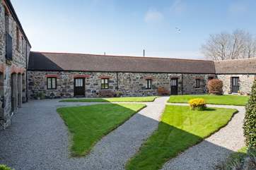 Viewed from across the shared courtyard garden, Kynance nestles quietly between its neighbours.