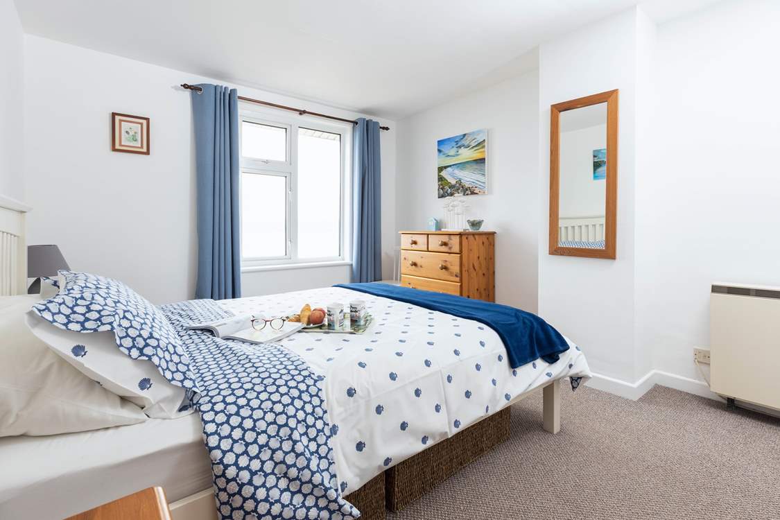 The spacious main bedroom with storage for your holiday belongings.