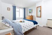 The spacious main bedroom with storage for your holiday belongings.