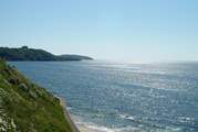 Looking from Gyllyngvase beach towards Pendennis Castle and The Roseland in the distance.