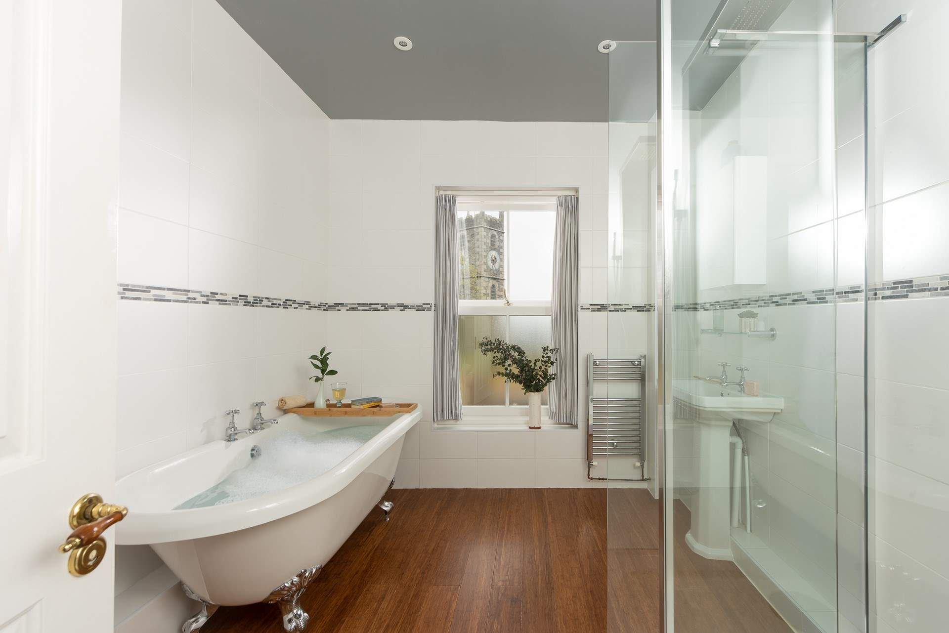 The family bathroom on the lower ground floor has a fabulous free-standing bath and separate shower.