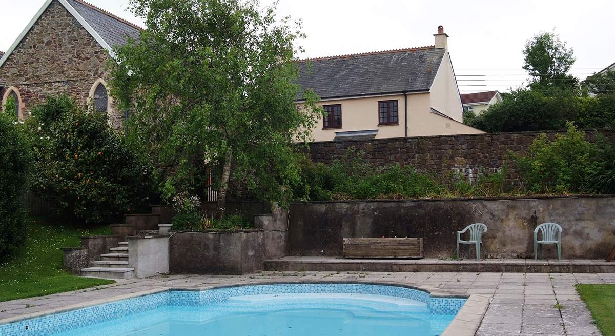 Orchard Dene is the cottage in the background. The gated steps lead down to the pool from a really large and private sun-trap patio behind the wall.