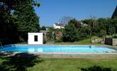 A view of the pool with steps on the right leading up to the patio. - Thumbnail Image