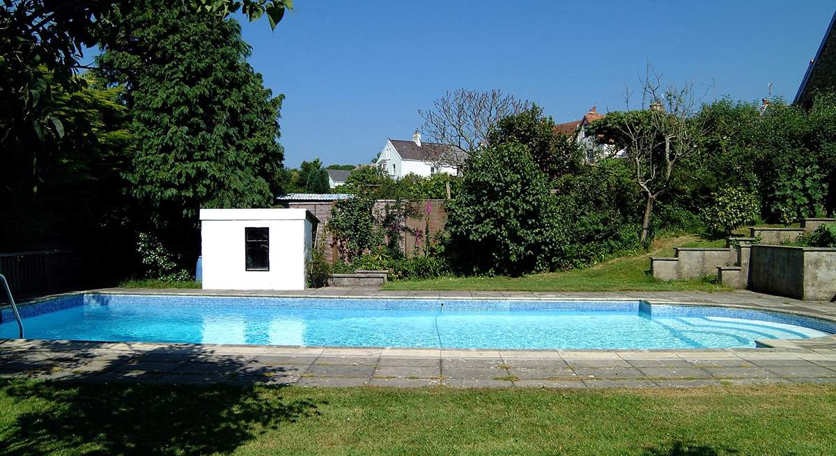 A view of the pool with steps on the right leading up to the patio.