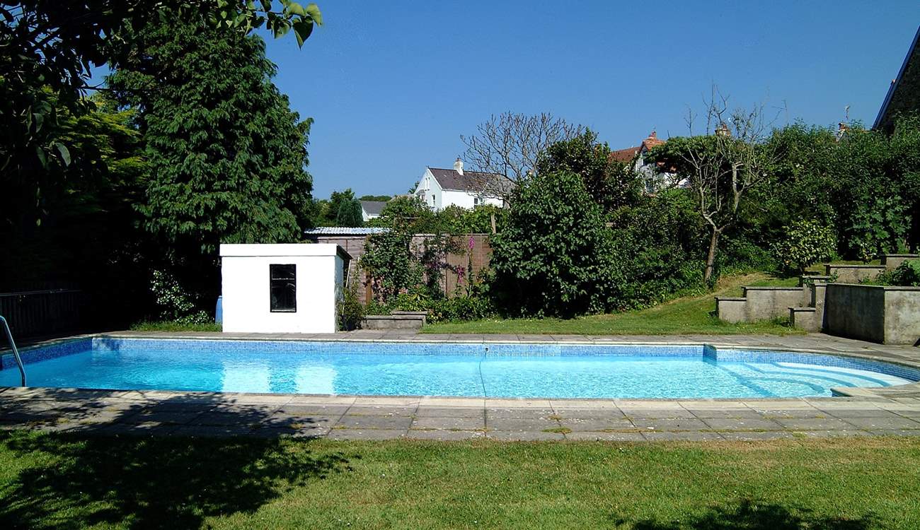 A view of the pool with steps on the right leading up to the patio.