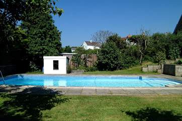 A view of the pool with steps on the right leading up to the patio.