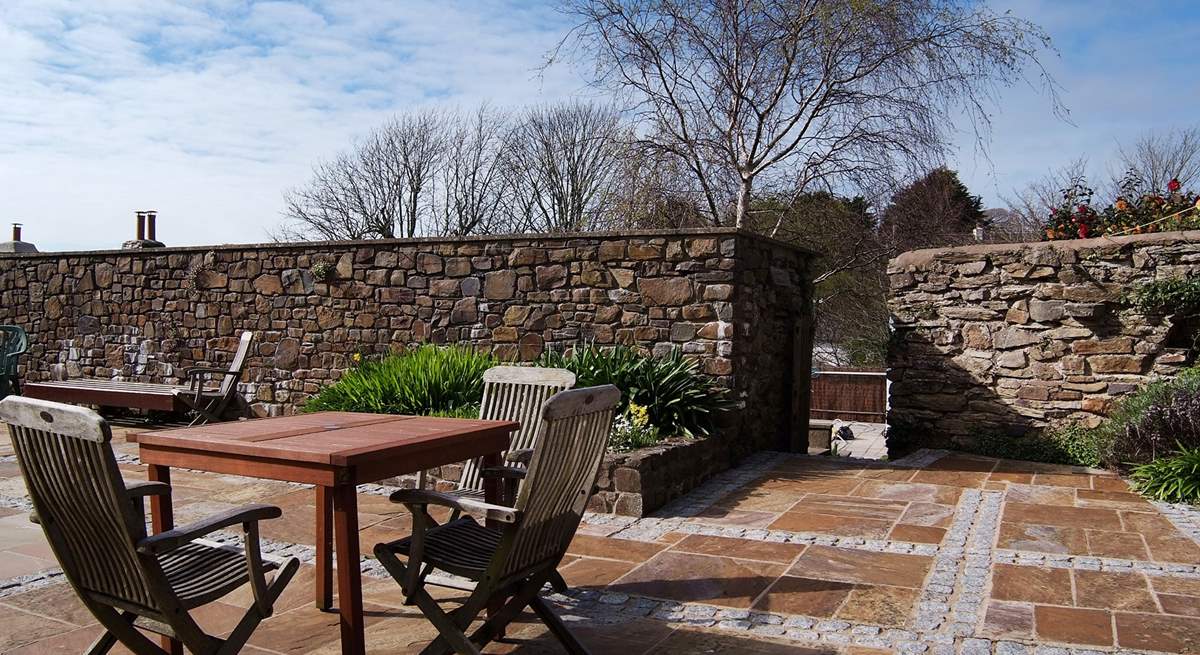 The private patio is sun-drenched - the gateway leads down to the swimming pool.