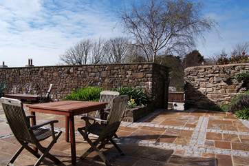 The private patio is sun-drenched - the gateway leads down to the swimming pool.
