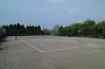 The full-size tennis court which guests are welcome to use.