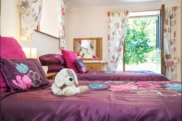 The second of the twin bedded room with patio doors elading out to the patio
