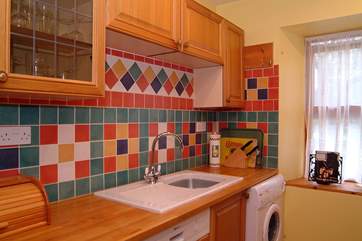 Colourful tiles brighten the kitchen.