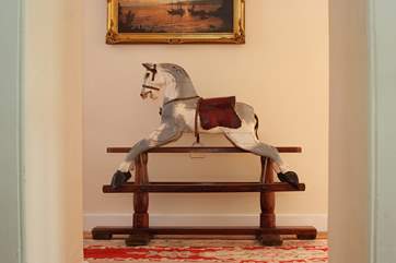 A lovely old rocking horse guards the landing upstairs.
