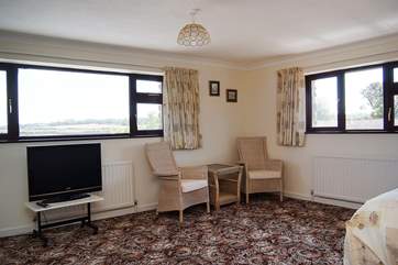 The huge master bedroom has an en suite bathroom and views across the estuary.