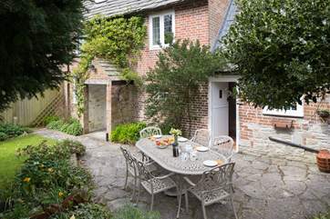The back of the cottage; doors from both the sitting-room and the kitchen open onto the patio and sheltered garden.