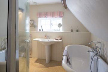 The spacious ensuite for the master bedroom has this wonderful roll-top bath and a separate shower cubicle too.
