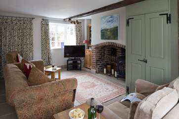 The cosy sitting-room has two sofas, relax with a glass of something delicious and unwind.