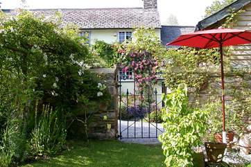 The cottage has its own garden to the right of the lane.