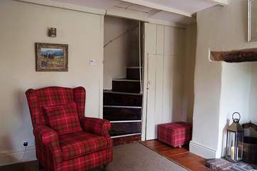 A lovely old armchair by the bottom of the steep stairs up to the bedroom.