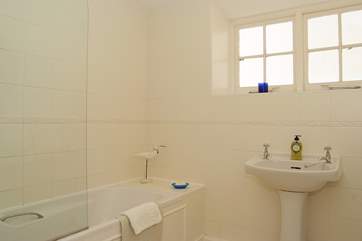 The bathroom has a fitted shower over the bath.