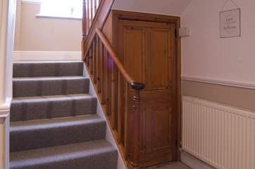 Stairs rising from the grand hallway to the first floor bedrooms, bedroom 2, the twin room is on the first landing.