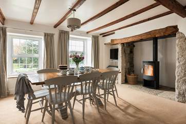 The dining-room has a wonderful wood-burner for cosy meals in and over looks the garden.