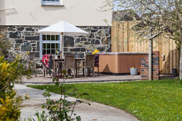 The hot tub is tucked away in a sheltered corner over looking the garden.