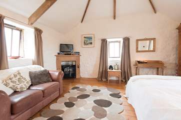 There is an electric wood-burning stove in the sitting-room.