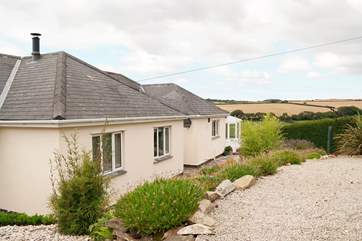 The front of the property where you can either access via the steps to the left of the picture, the steps in front or down the gravelled slope.