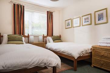 Bedroom 3 is furnished with twin beds.