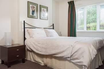 Spacious en suite Bedroom 2 has a king-size bed.