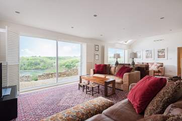 The enormous main sitting-room is hugely spacious and filled with natural light.