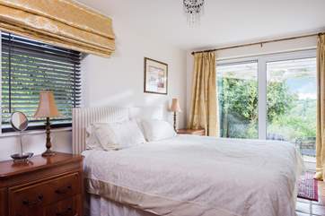 Bedroom 4 has 'zip and link' (double or twin) beds, and the patio doors provide lovely views of the creek whatever the weather or season.